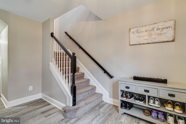 staircase with wood-type flooring