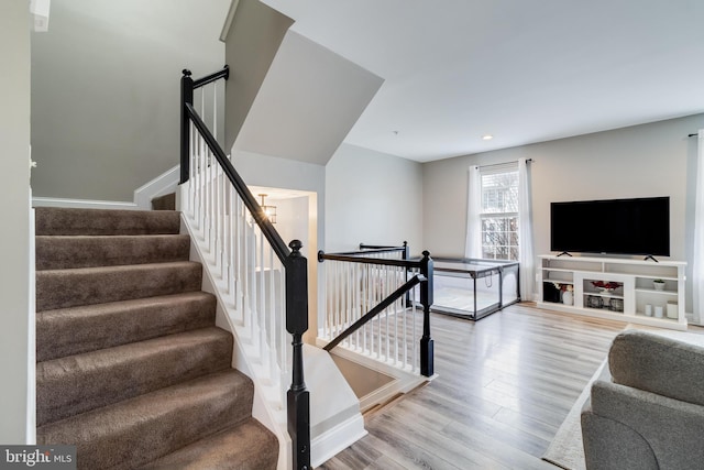 stairs with hardwood / wood-style flooring