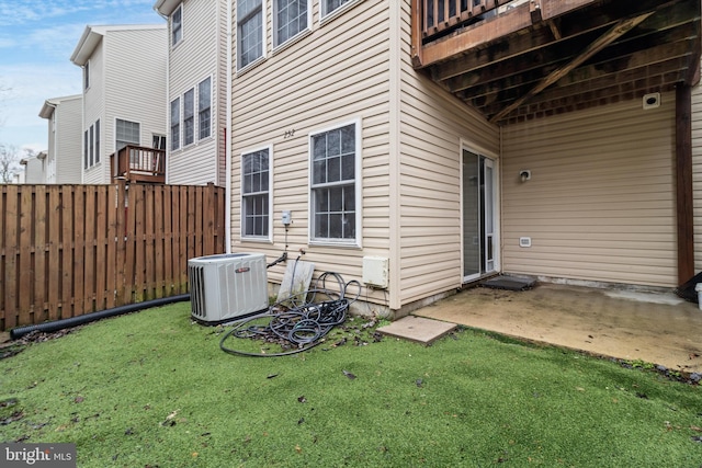 exterior space with a patio, a lawn, and central air condition unit