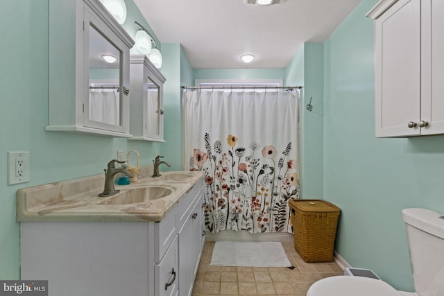 bathroom featuring vanity, toilet, and a shower with shower curtain