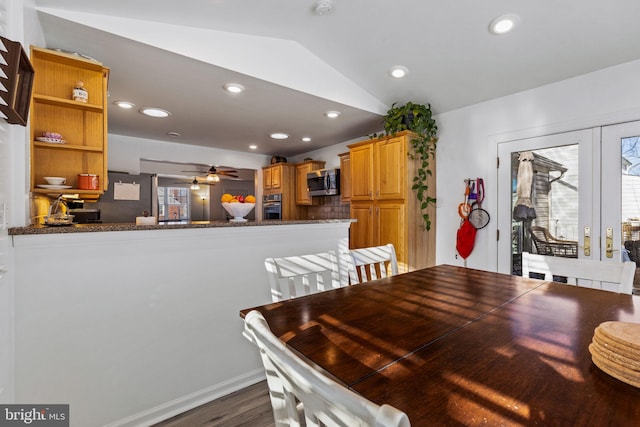 dining room with lofted ceiling, dark hardwood / wood-style flooring, and ceiling fan