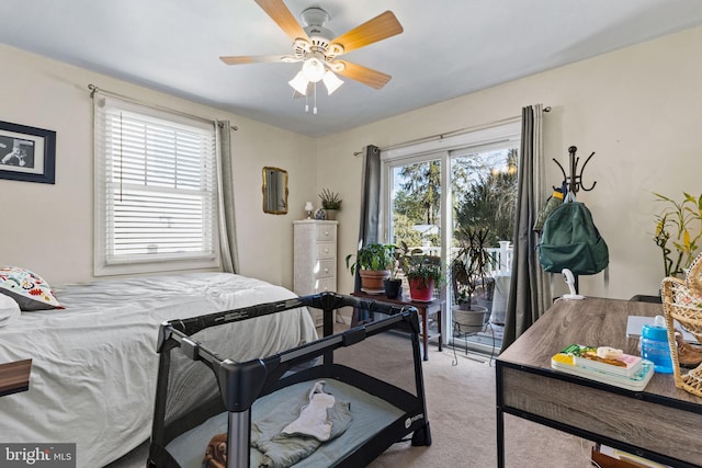 carpeted bedroom with access to outside and ceiling fan