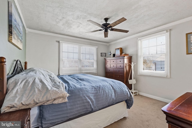 carpeted bedroom featuring ceiling fan, ornamental molding, and a textured ceiling