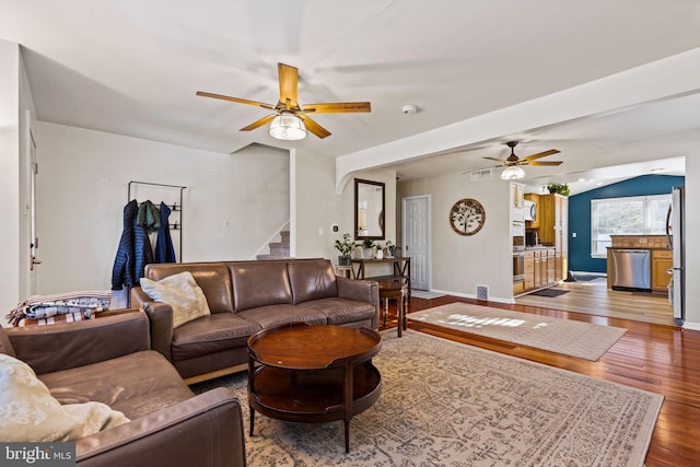 living room featuring vaulted ceiling, ceiling fan, and hardwood / wood-style floors