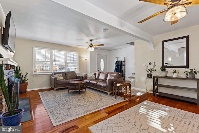 living room featuring ceiling fan and dark hardwood / wood-style floors