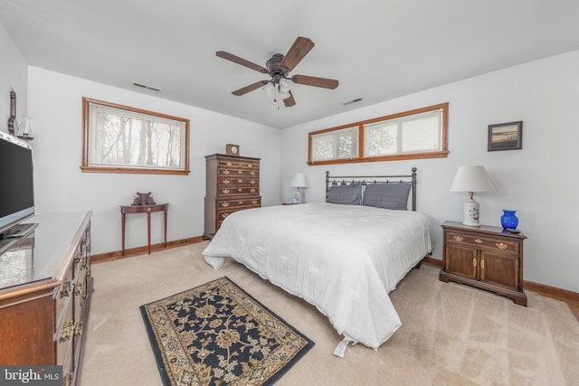 bedroom featuring visible vents, light carpet, baseboards, and multiple windows