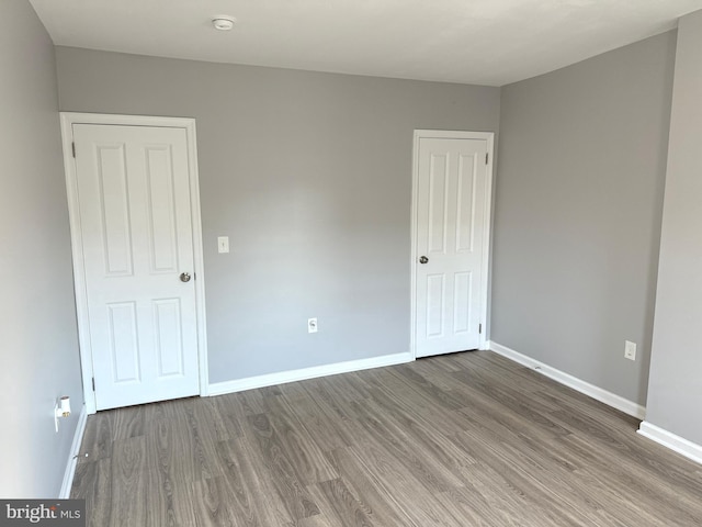 unfurnished room featuring hardwood / wood-style flooring