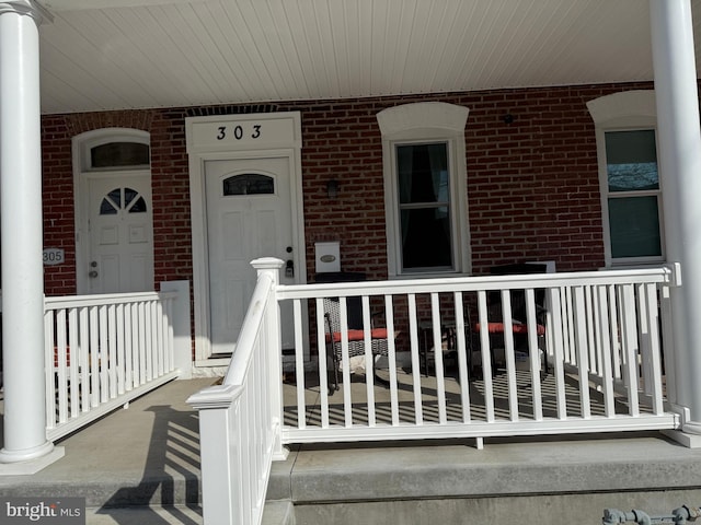 view of exterior entry with covered porch