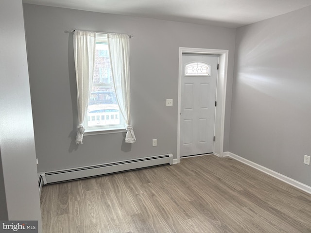 foyer with a baseboard radiator and light hardwood / wood-style floors