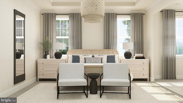 carpeted bedroom featuring multiple windows, a tray ceiling, and ornamental molding