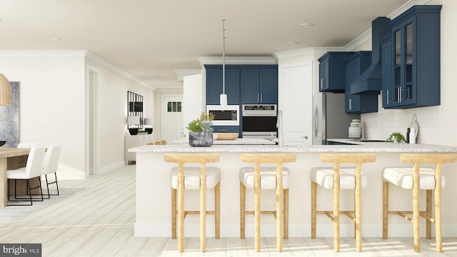 kitchen with backsplash, stainless steel appliances, a kitchen breakfast bar, and blue cabinets