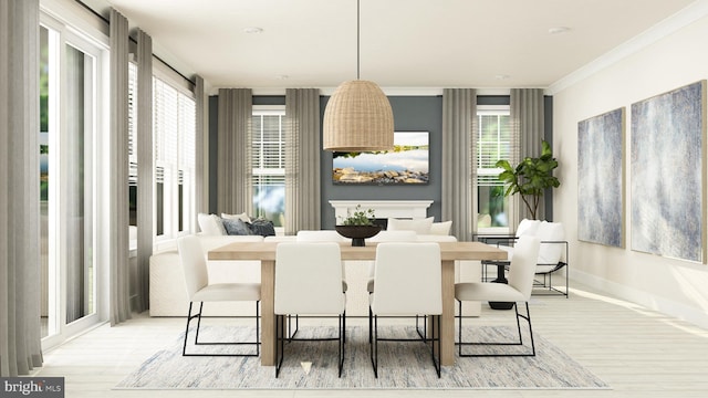 dining space with crown molding and light hardwood / wood-style flooring