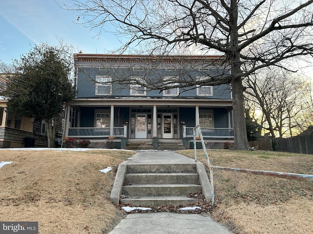 view of front of home with fence and a porch