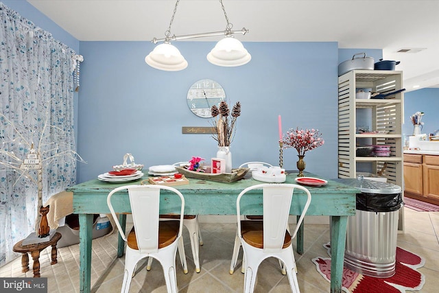 dining area featuring light tile patterned floors