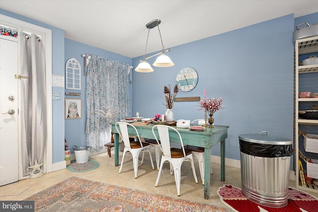 dining space featuring light tile patterned flooring