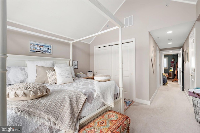 bedroom featuring light colored carpet and high vaulted ceiling