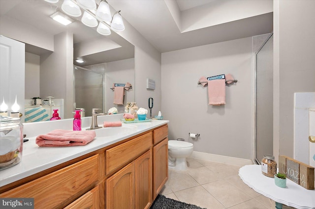 bathroom featuring vanity, tile patterned floors, a shower with door, and toilet