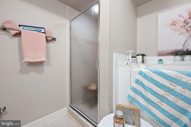 bathroom featuring walk in shower and tile patterned flooring