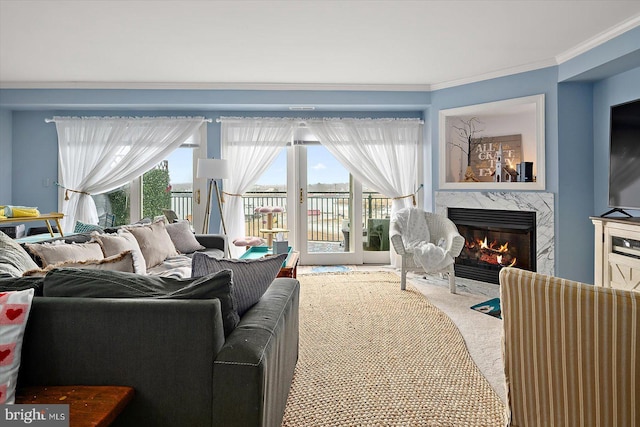 carpeted living room with crown molding, plenty of natural light, and a fireplace