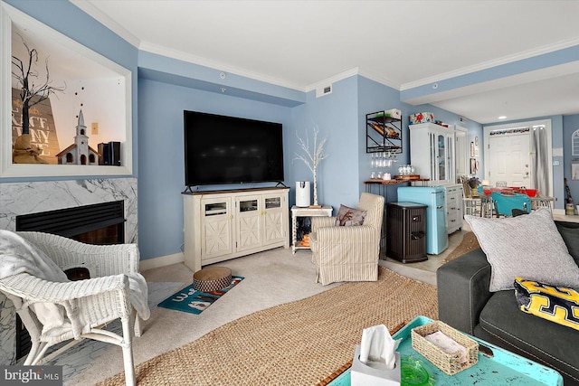 carpeted living room with crown molding and a fireplace