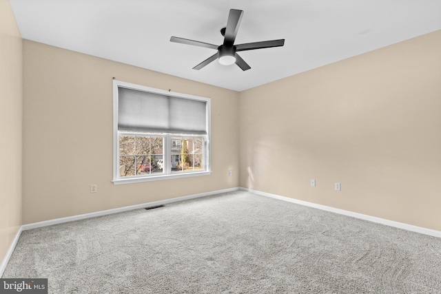 spare room with carpet and ceiling fan