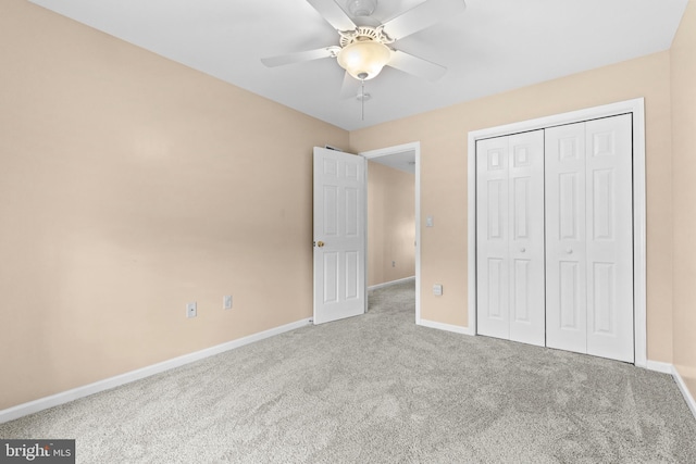 unfurnished bedroom featuring carpet, ceiling fan, and a closet