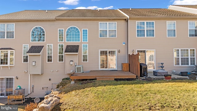 rear view of house with a wooden deck, a yard, and central air condition unit