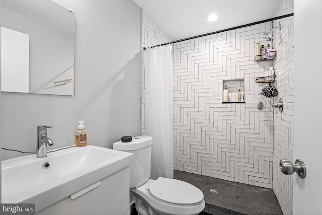 bathroom with walk in shower, toilet, and sink