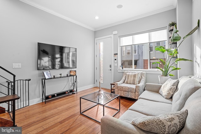 living room with hardwood / wood-style flooring and ornamental molding