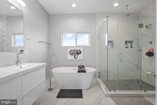 bathroom featuring vanity and shower with separate bathtub