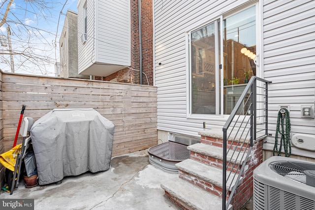 view of patio with a grill and central air condition unit