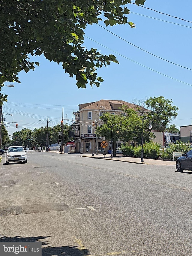 view of street with curbs, traffic lights, and sidewalks