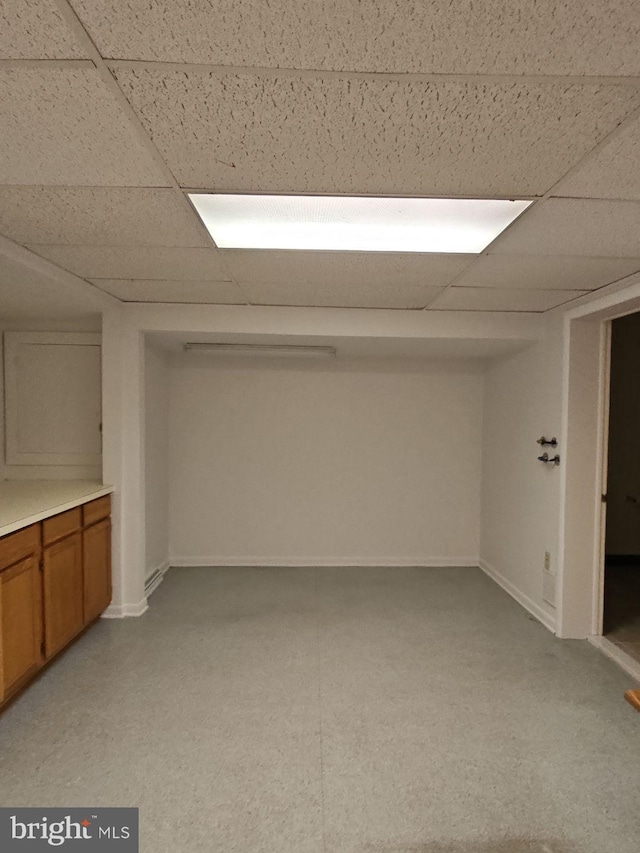 basement featuring a drop ceiling