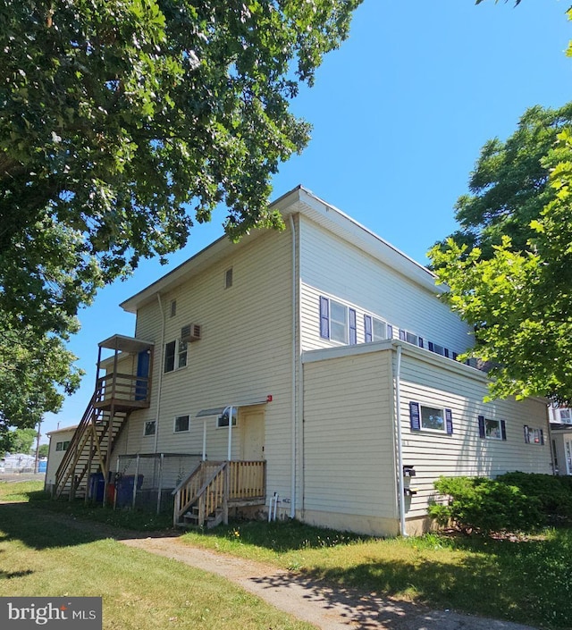 exterior space with a yard and stairs