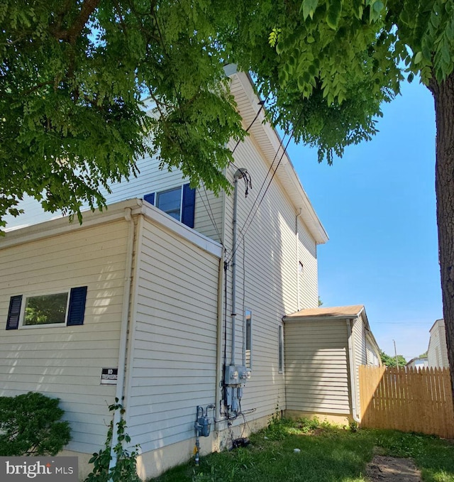 view of side of property featuring fence