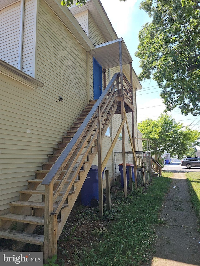 view of side of home featuring stairway