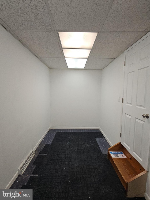 interior space featuring a drop ceiling, visible vents, and baseboards