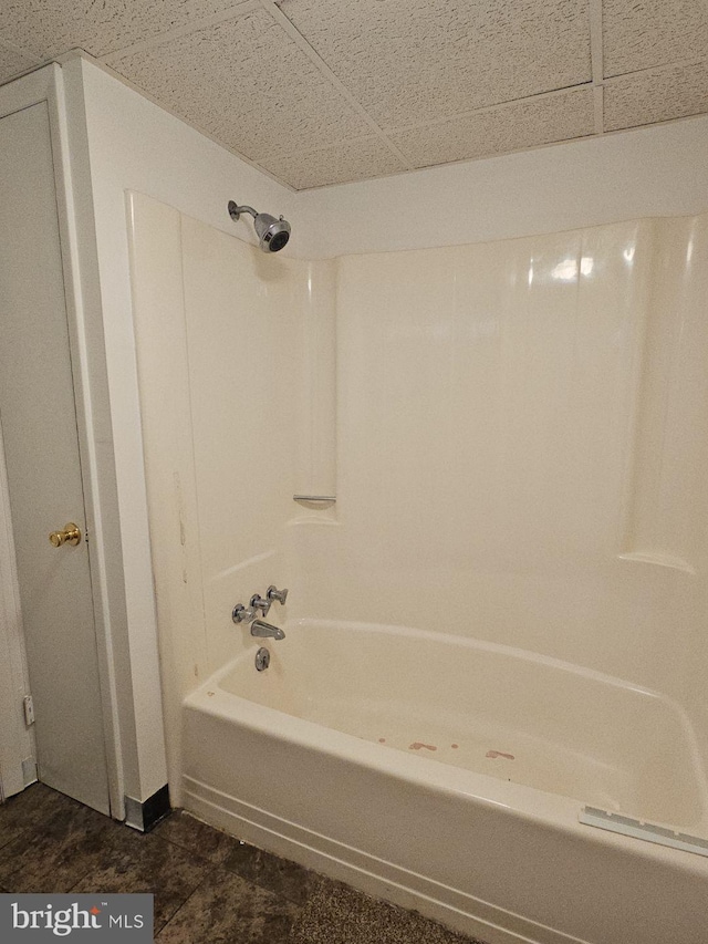 bathroom featuring a drop ceiling and shower / bathing tub combination