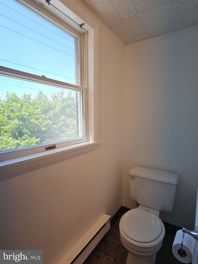 bathroom featuring toilet and a drop ceiling