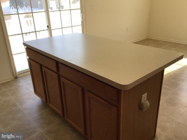 kitchen with light tile patterned floors and a kitchen island