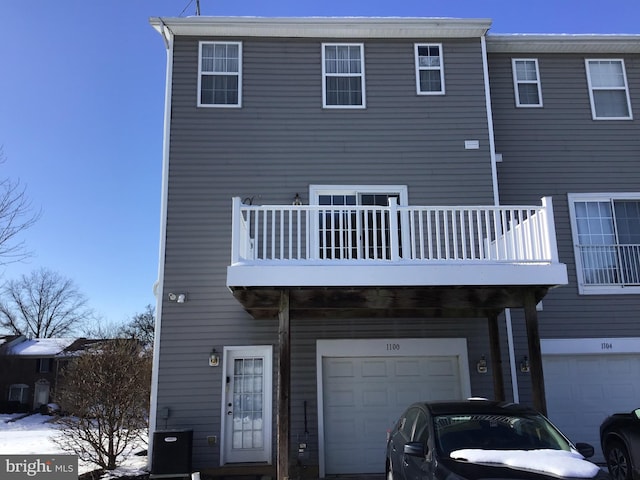 rear view of house featuring a garage