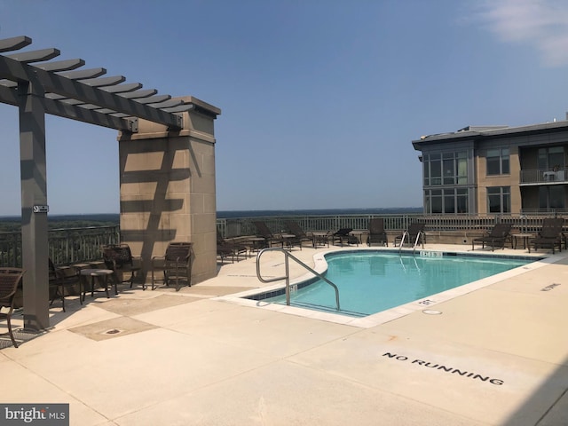 community pool with a patio and a pergola