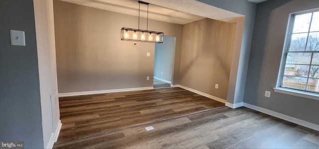 unfurnished dining area with dark hardwood / wood-style flooring