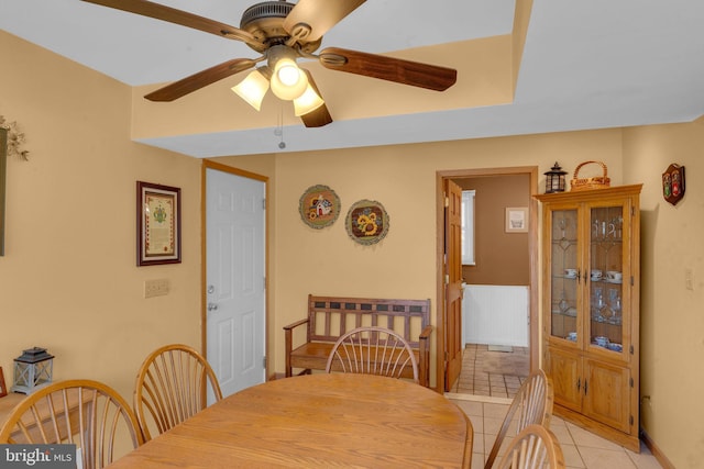 tiled dining room with ceiling fan and radiator heating unit