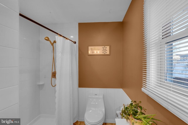 bathroom with a shower with curtain and toilet