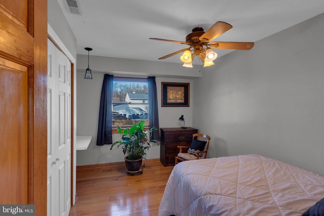 bedroom with ceiling fan and light wood-type flooring