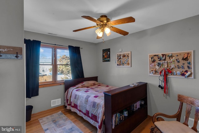 bedroom with light hardwood / wood-style floors and ceiling fan