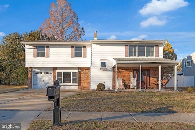 view of front of house with a garage, covered porch, and a front lawn