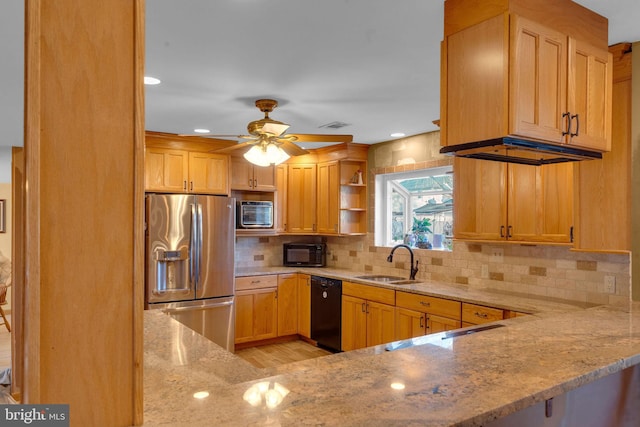 kitchen with sink, black dishwasher, stainless steel refrigerator with ice dispenser, light stone counters, and kitchen peninsula