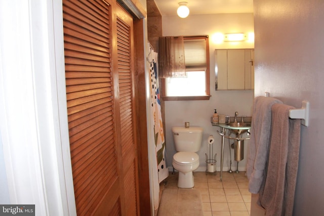 bathroom with tile patterned floors and toilet